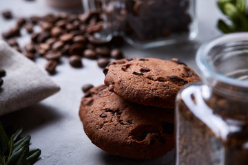 Morning coffee in white cup, chocolate chips cookies on homespun napkin, close-up, selective focus