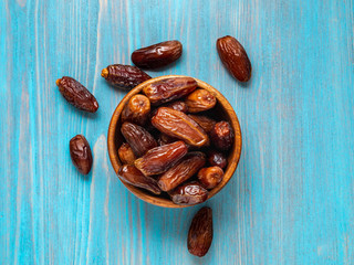 Fruits of date palm, dried fruits in wooden bowl. Traditional food of the middle East and North...