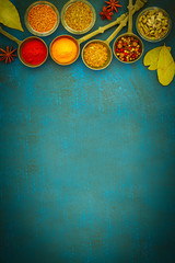 Wooden table of colorful spices © alefat