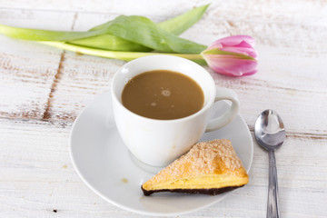 cup of coffee and tulip and cake