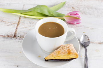 cup of coffee and tulip and cake