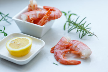 row tiger shrimp with lemon on white