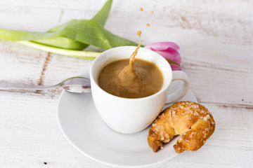 cup of coffee and tulip and cake