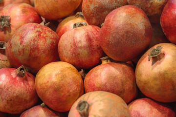 A pile of pomegranates in market as background, texture