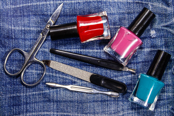 Basic set of manicure tools on jeans background
