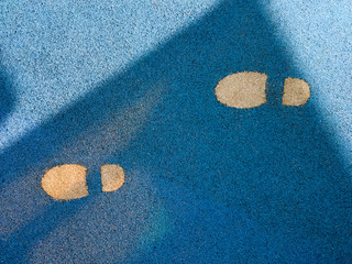 Track shoes in the sand.