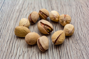 Pistachios on wooden table.