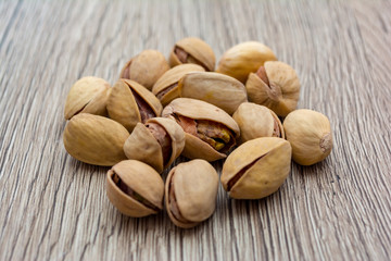 Pistachios on wooden table.