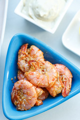 row tiger shrimp with lemon on white