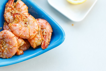 row tiger shrimp with lemon on white