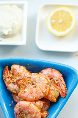 row tiger shrimp with lemon on white
