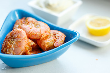 row tiger shrimp with lemon on white