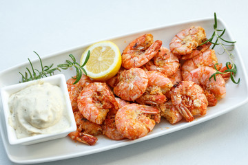 row tiger shrimp with lemon on white