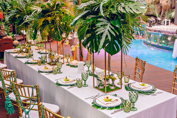 Served table at a tropical party decorated with orchids