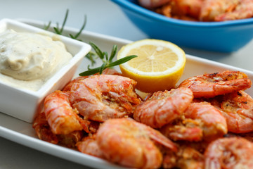 row tiger shrimp with lemon on white