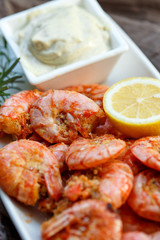 row tiger shrimp with lemon on brown