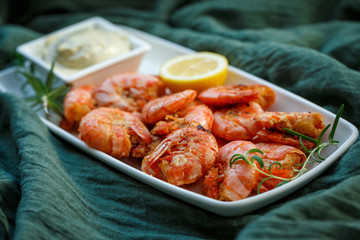 row tiger shrimp with lemon on green