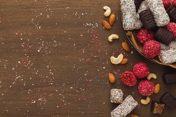 Wooden desktop with assortment of healthy sweets and nuts