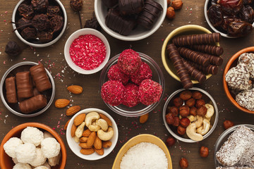 Wooden desktop with assortment of healthy sweets and nuts