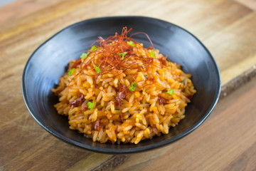Food photography of a black bowl with red rice