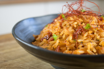 Food photography of a black bowl with red rice