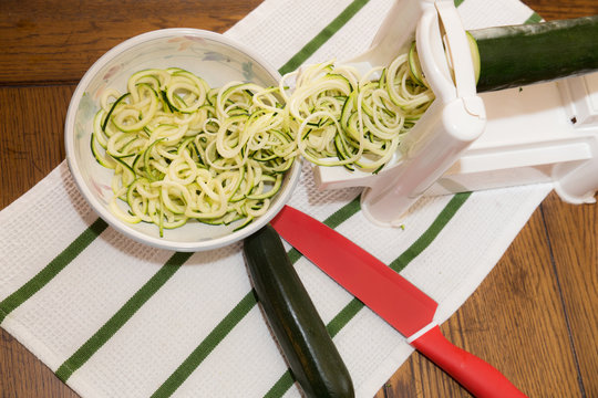 Spiral zucchini noodles called zoodles prepared in spiralizer kitchen gadget