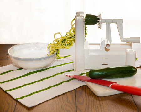 Spiral zucchini noodles called zoodles prepared in spiralizer kitchen gadget