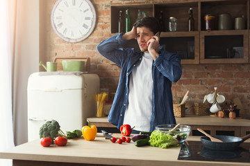 Disappointed man preparing healthy food in the home kitchen