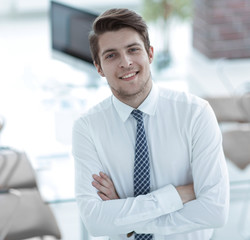 confident young businessman on background of office