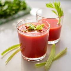 tomato juice in a glass with greens