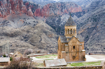 Fototapeta na wymiar Scenic Novarank monastery in Armenia. Noravank monastery was founded in 1205. It is located 122 km from Yerevan in a narrow gorge made by the Darichay river nearby the city of Yeghegnadzor
