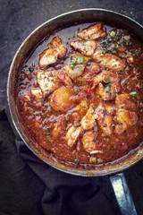 Traditional Creole cajun court bouillon with fish and seafood gumbo chowder stew as top view in a pot