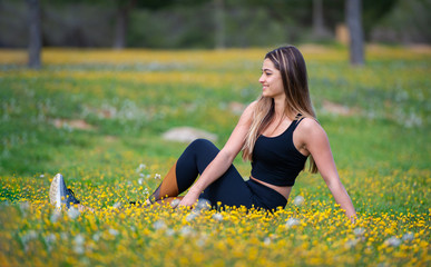 blonde woman stretching in a field