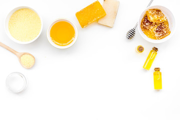 Homemade cosmetics with honey. Handmade soap, spa salt, cream on white background top view