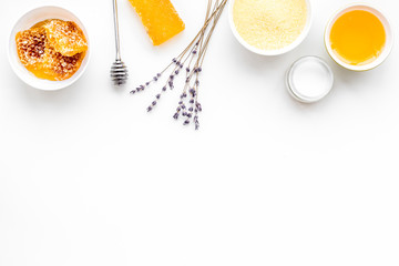 Homemade cosmetics with honey. Handmade soap, spa salt, cream on white background top view copy space