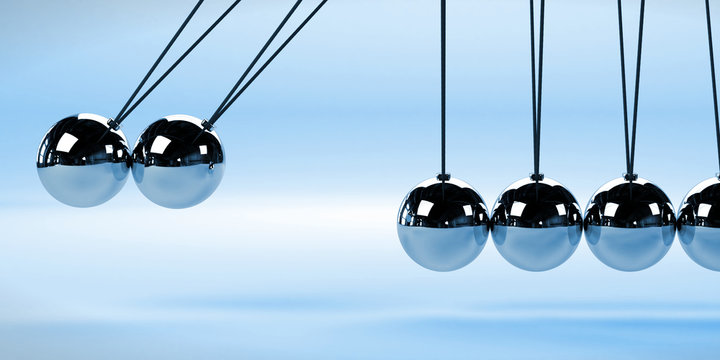 Newton's cradle, action and reaction concept with two moving balls, metal on a white background