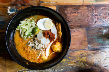 Serving of Nyonya Laksa, popular spicy noodle soup in Malaysia
