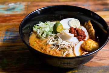 Serving of Nyonya Laksa, popular spicy noodle soup in Malaysia