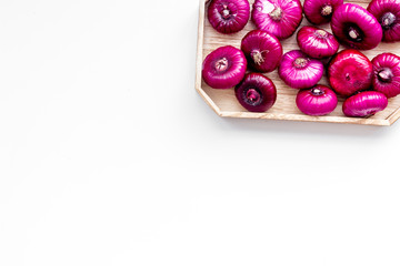 Red onion is healthy product. Onion bulbs in tray on white background top view space for text