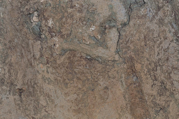 Brown textured concrete textured wall background. Stone or slate surface. Beige wall with cracks. Isolated horizontal shot. Dark colours