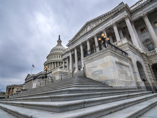 The United States capitol building with dark sclouds above