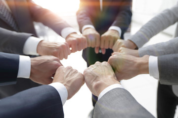 closeup.business people show a circle of hands.
