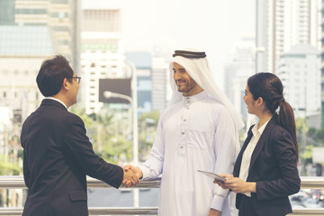 Arab businessman make a handshake with his partnership. First meeting with partner, secretary support to translate language during business talk. Happiness and smiling conference with successful deal