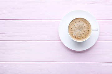 Cup of coffee on pink wooden table