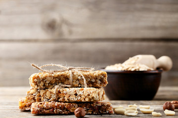 Granola bars with nuts on wooden table