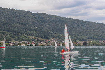 ANNECY, FRANCE - SEPTEMBER 21, 2012: Sailing on lake Annecy. Annecy, France.