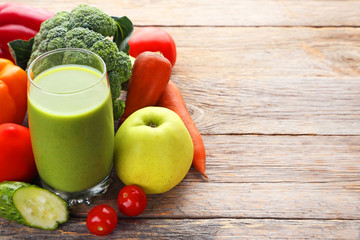 Vegetables smoothie in glasses on grey wooden table