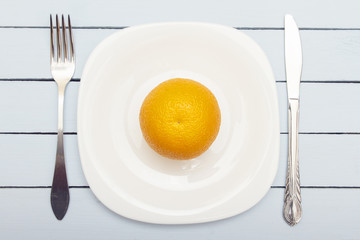 Ripe juicy orange on wooden table. Vegetarian food concept. Top view and copy space