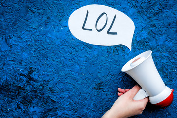 Reaction to something funny. Internet meme LOL. Megaphone near cloud with word LOL on blue...