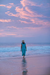 Woman at the seashore of Indian ocean after sunset